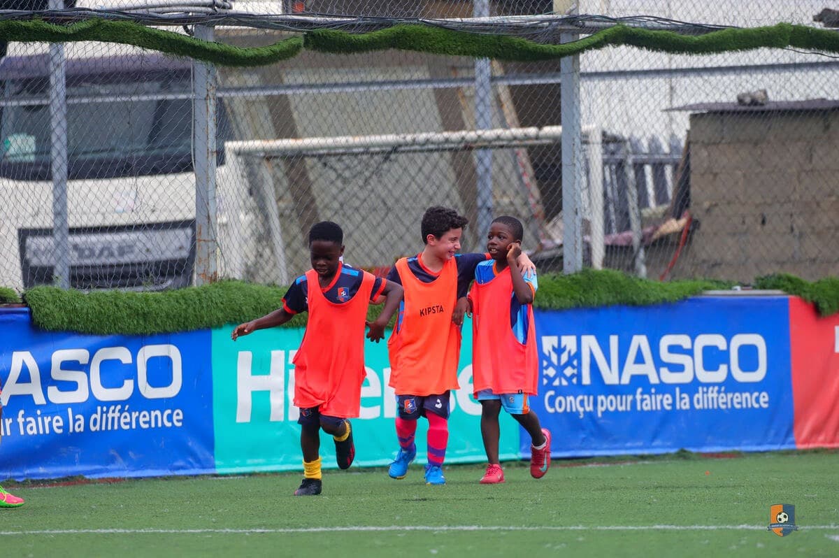 Bright Academy players huddled together on the pitch