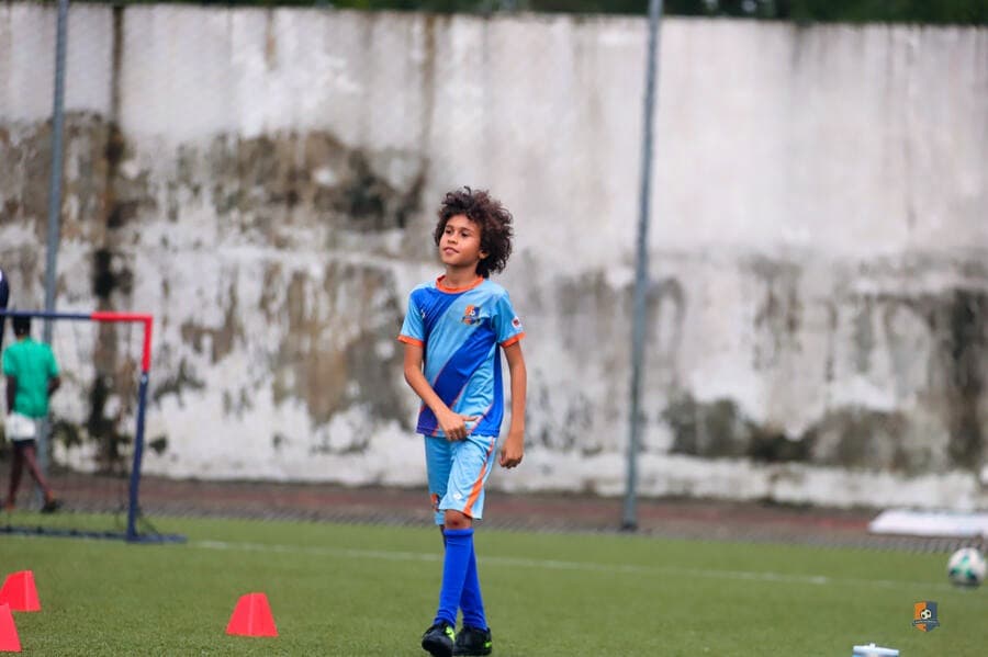 Bright Academy player waiting on the pitch before training