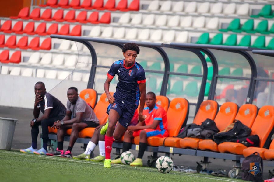 Bright Academy players seated on the bench ahead of a match