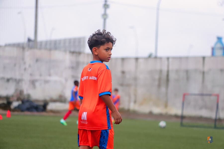 Young Bright Academy player on the sideline during a session