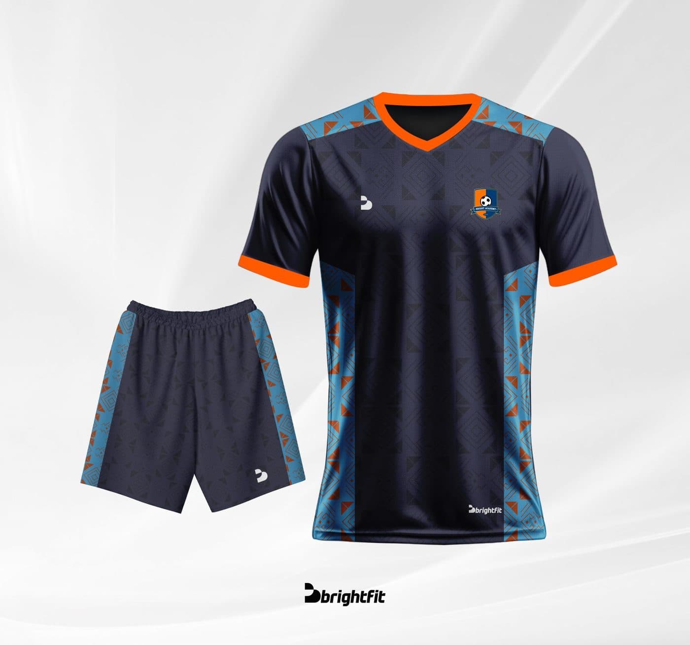 Bright Academy away kit — navy jersey and shorts with orange trim and blue side panels, official BrightFit product render